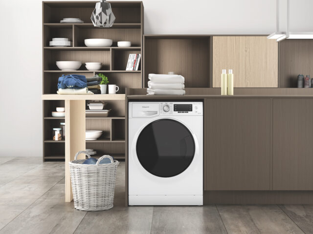 A Hotpoint washing machine installed in a kitchen