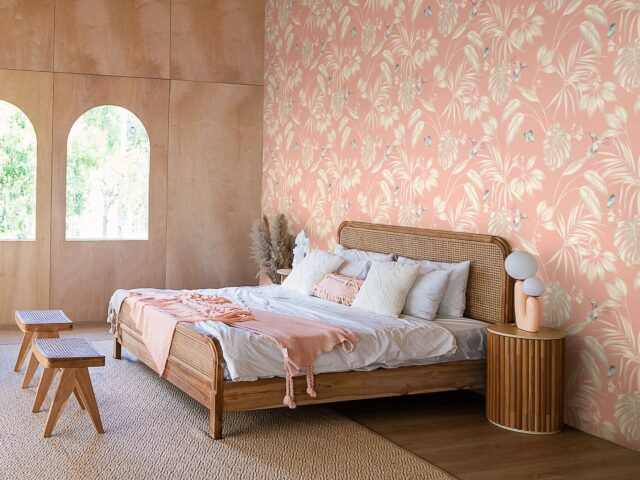 Interior of bedroom with wooden double bed white pillows.