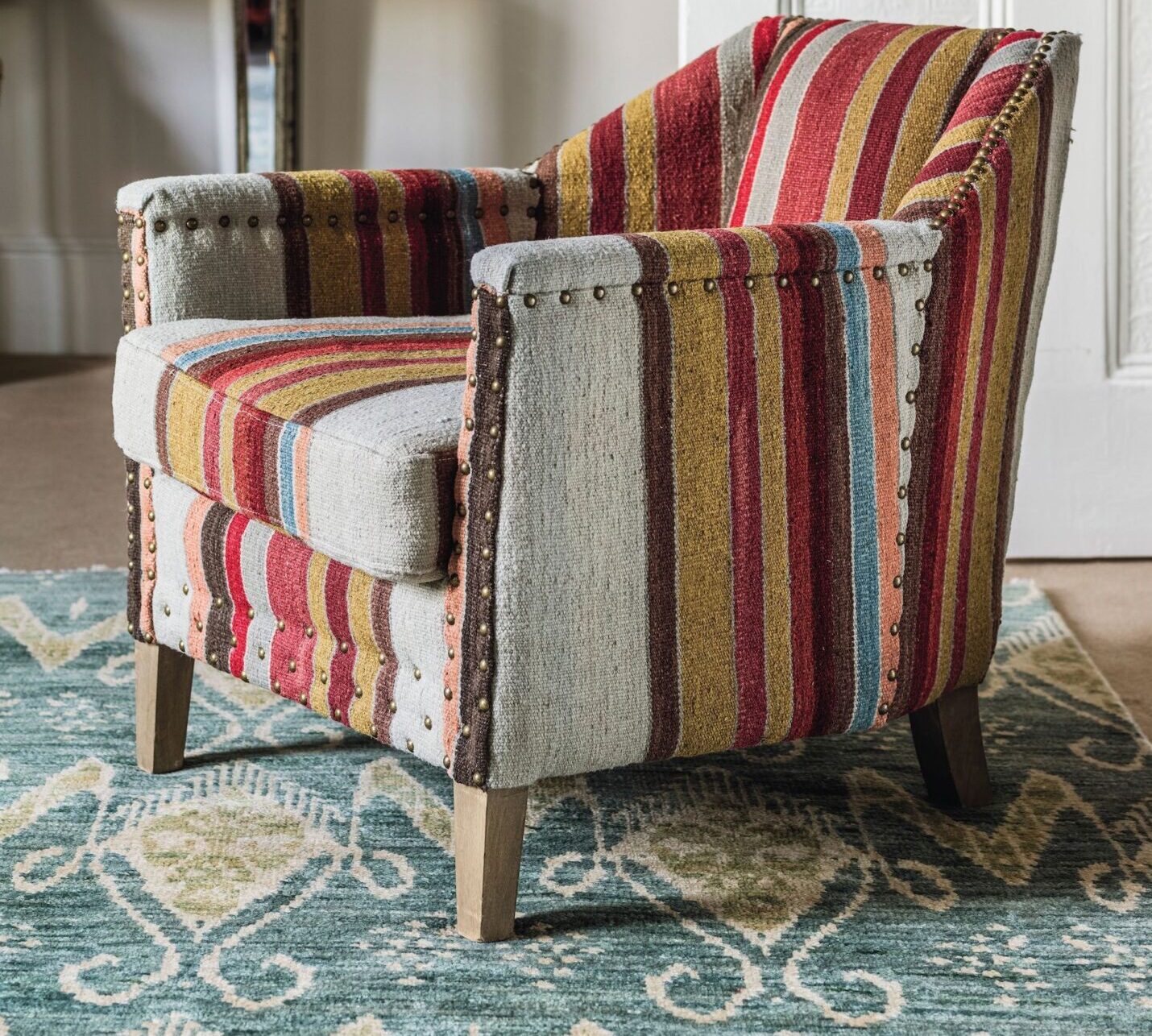 A striped bold OKA armchair