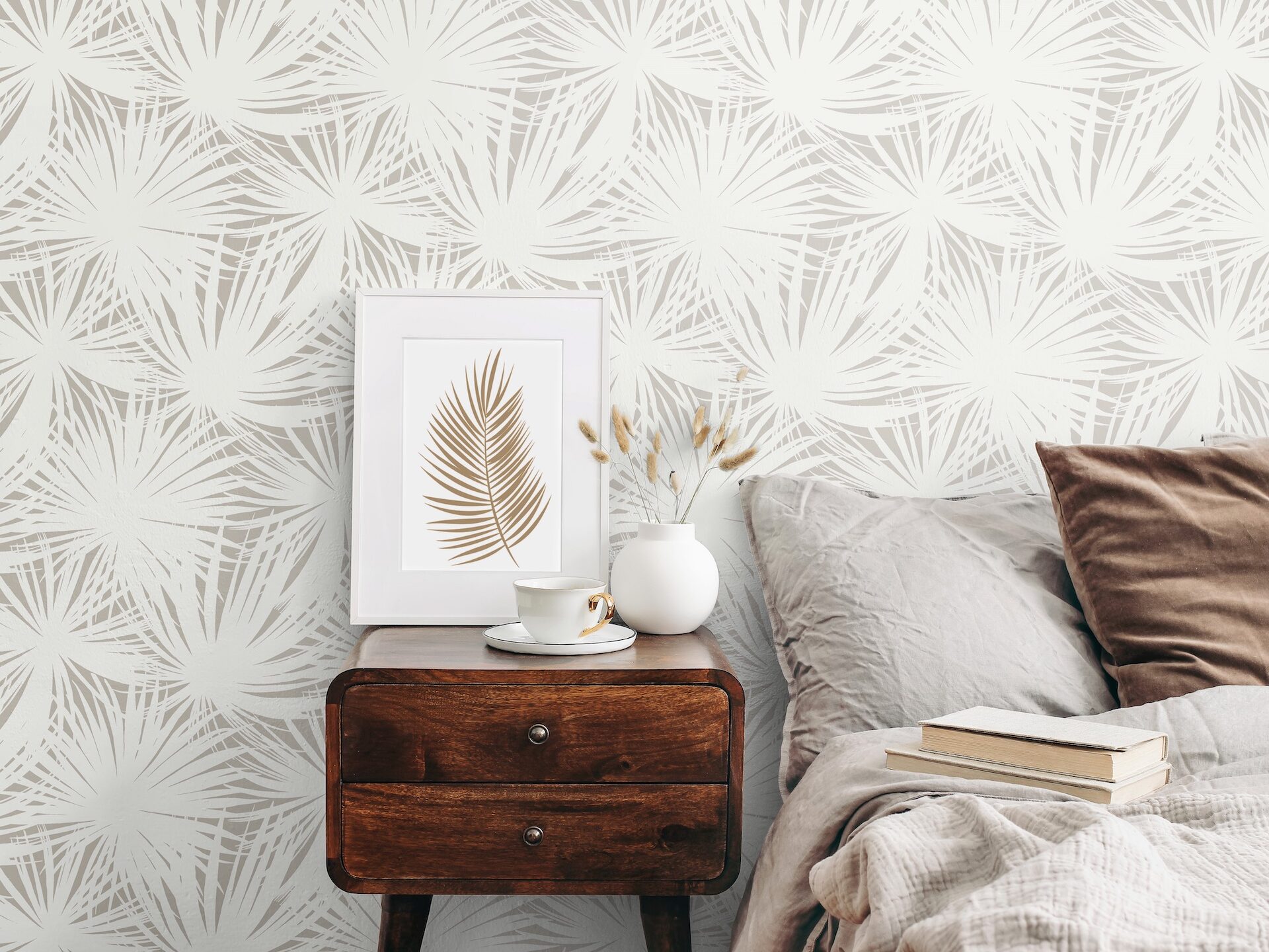 Palm wallpaper. White frame mockup on retro wooden bedside table. Modern white ceramic vase with dry Lagurus ovatus grass and cup of coffee. Beige linen and velvet pillows in bedroom, Scandinavian interior.