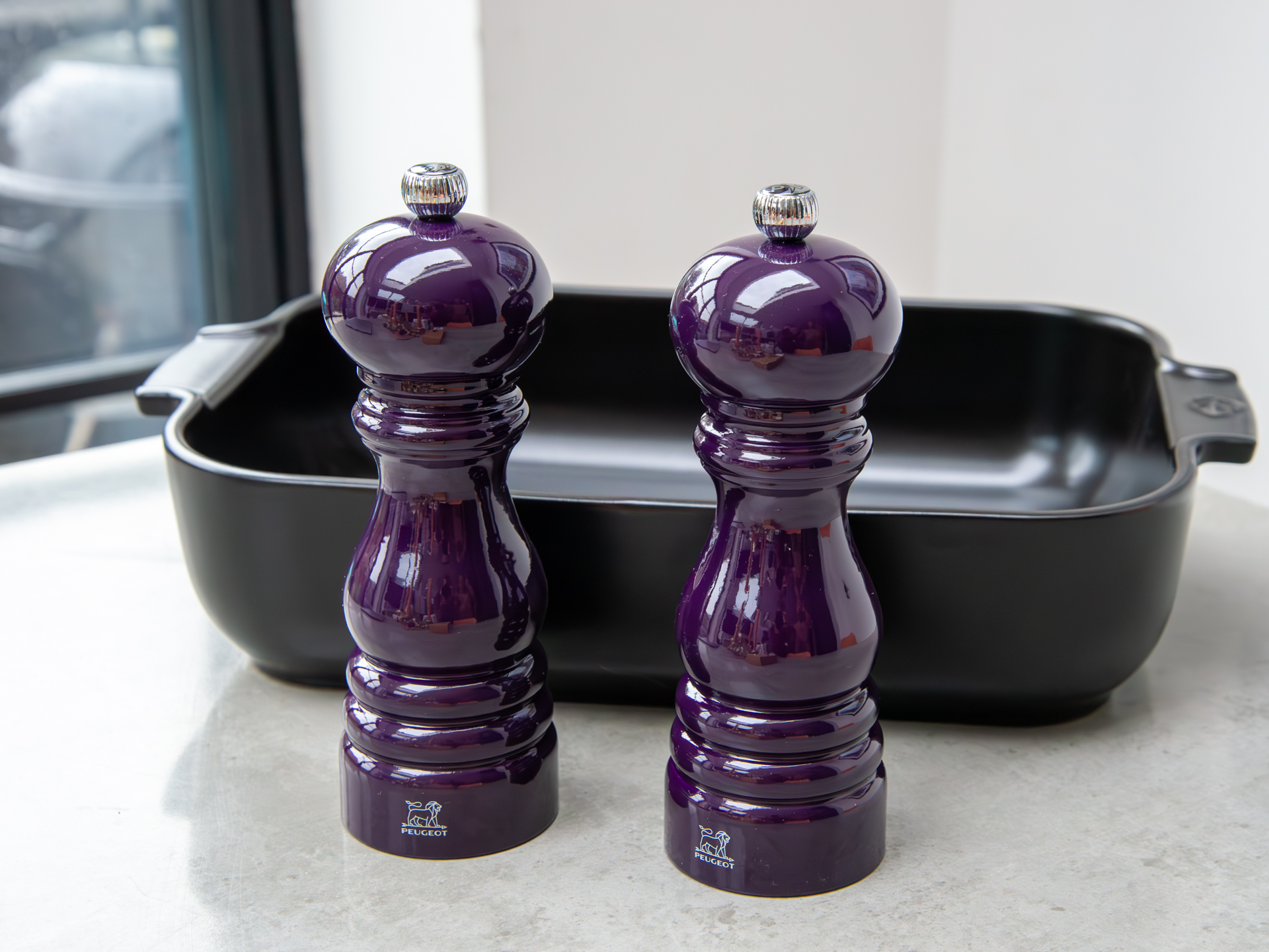 Peugeot purple homeware - salt and pepper mills, and an oven dish