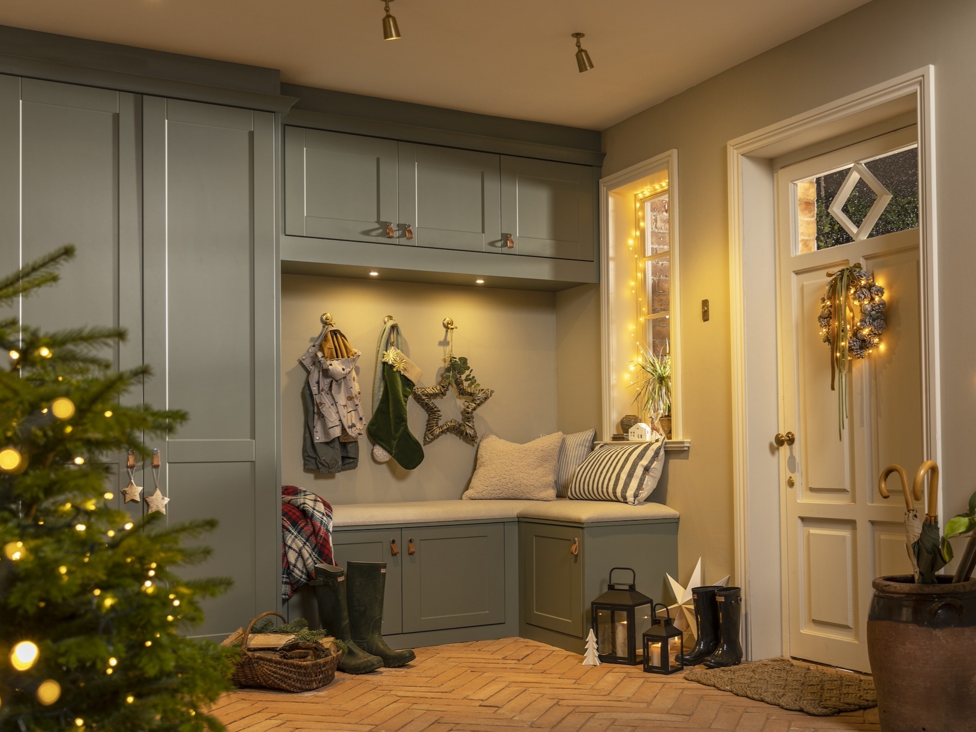 Boot room with willow green built in furniture and Christmas tree