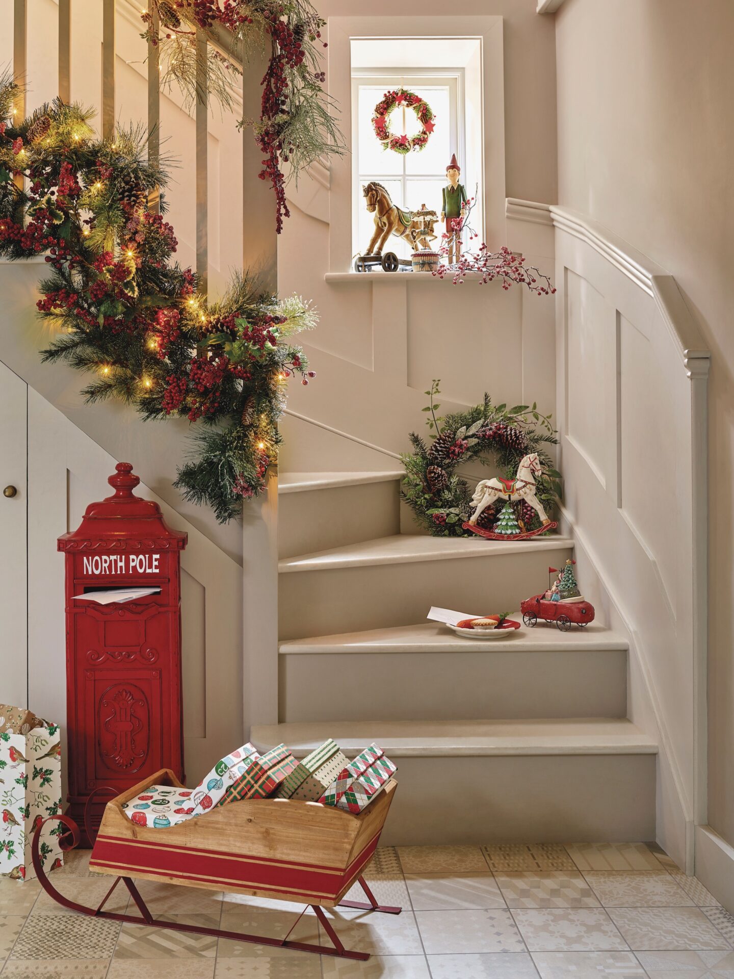 Neutral hallway with red post box and mini sleigh