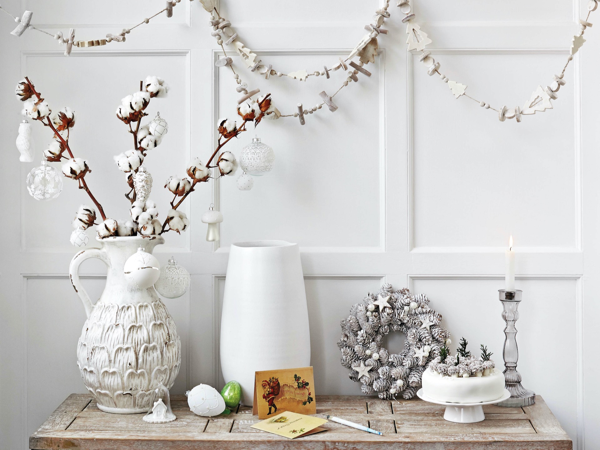 Console table with collection of white Christmas-themed ceramics