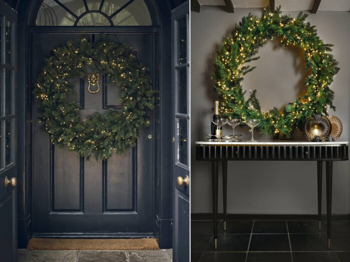 Giant Christmas wreaths hung on front door and resting on console table