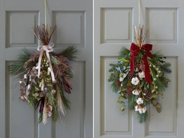 Two pale grey front doors with swags for foliage tied with ribbon
