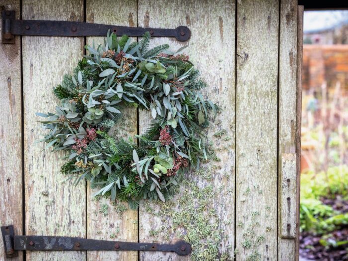 Mixed eucalyptus and green pine wreath on garden gate