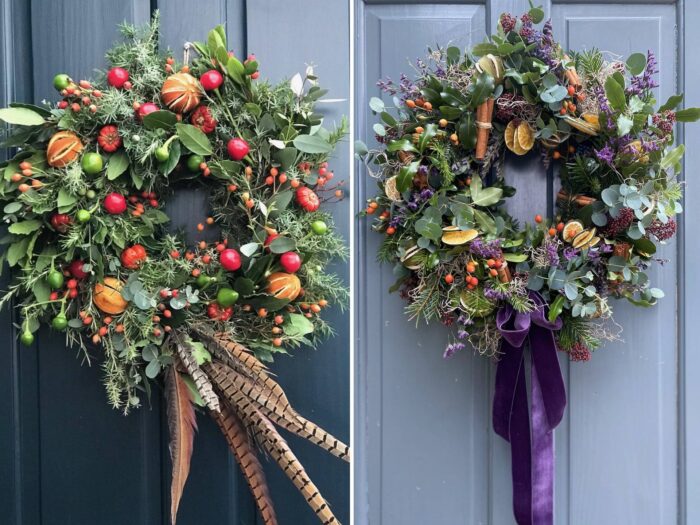 Christmas wreaths on blue grey doors with fruits, features and ribbon