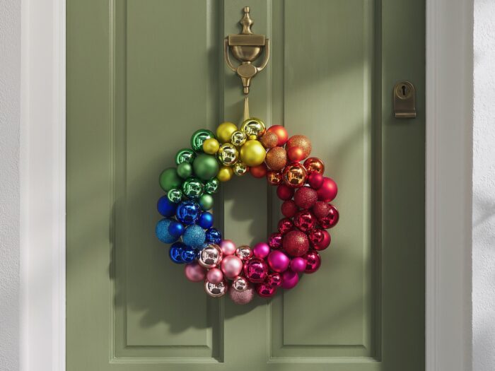 Multicolour bauble wreath hanging on front door