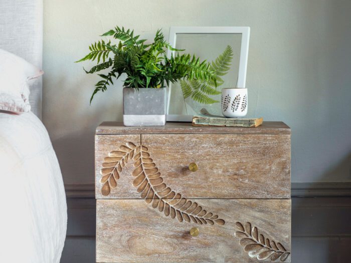 A fern on a fern print bedside table