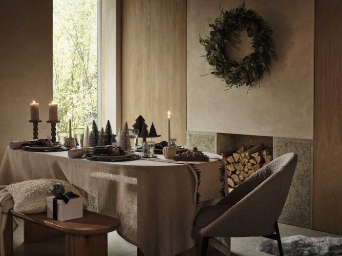 A warm cosy Christmas is filled with soft candlelight and festive foliage