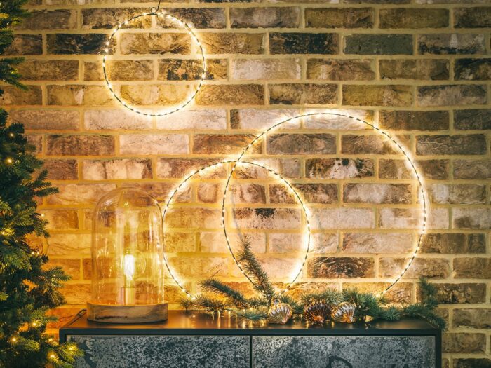 Circle ring light wreaths resting on sideboard