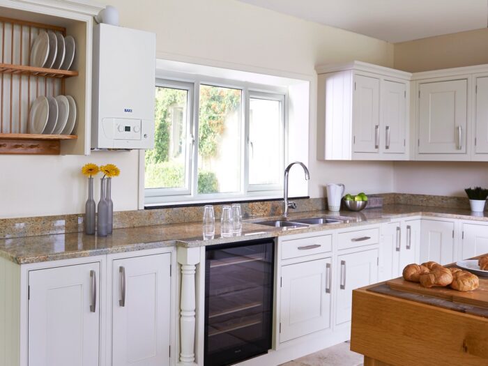 White kitchen with exposed Baxi boiler