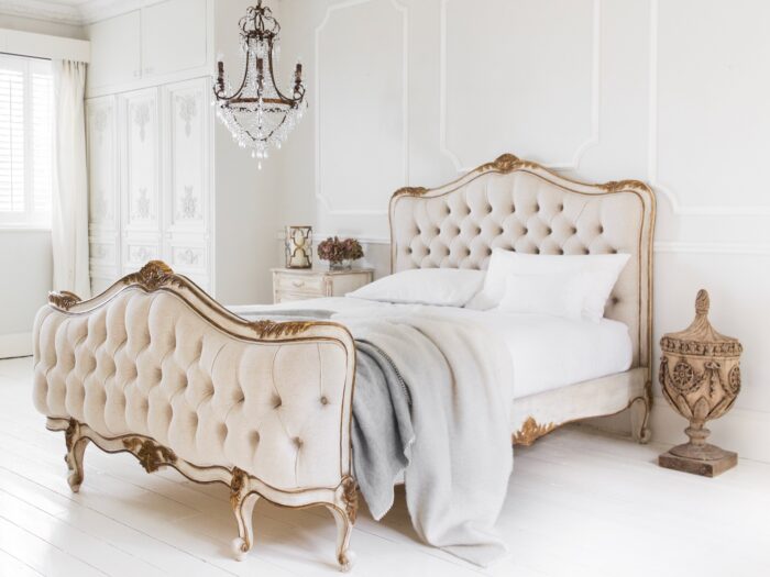 Upholstered bed with gold detail