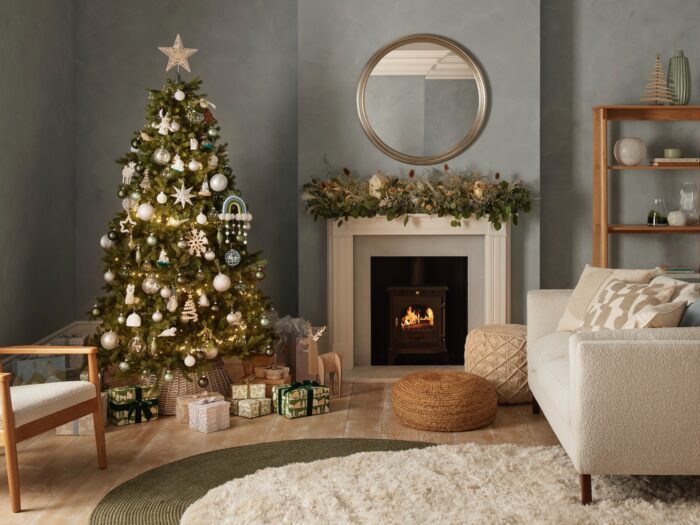 Christmas tree in blue-grey sitting room with boucle white sofa