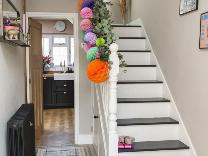 Garland and colourful paper baubles in modern hallway