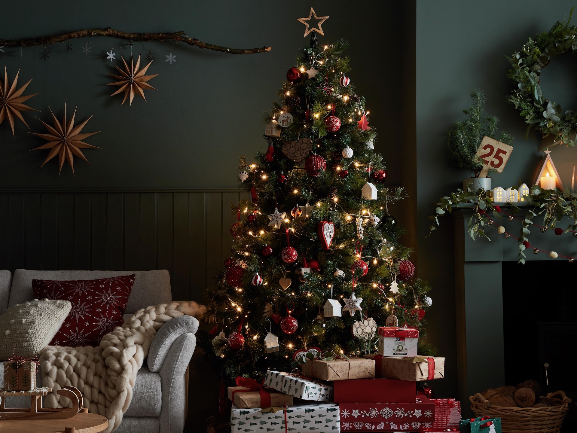 Christmas tree in dark living room with Sofology sofa