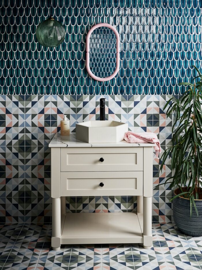 Geometric tiles paired with blue tiles and cream vanity unit
