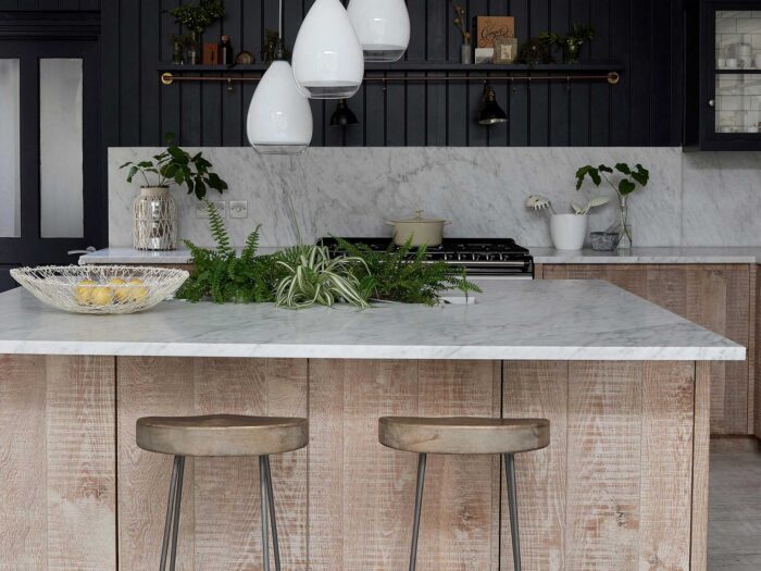 One of the pros of adding a kitchen island is that you can add texture with wood and marble