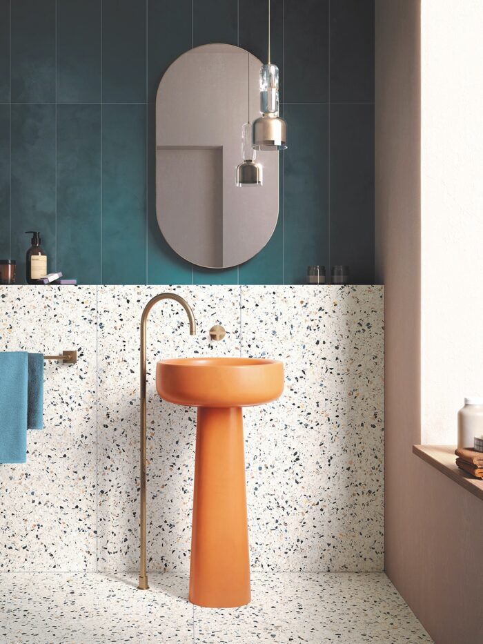 Terrazzo tiles with orange pedestal basin