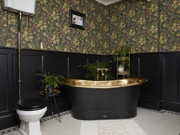 Gold lined bath and toilet in bathroom