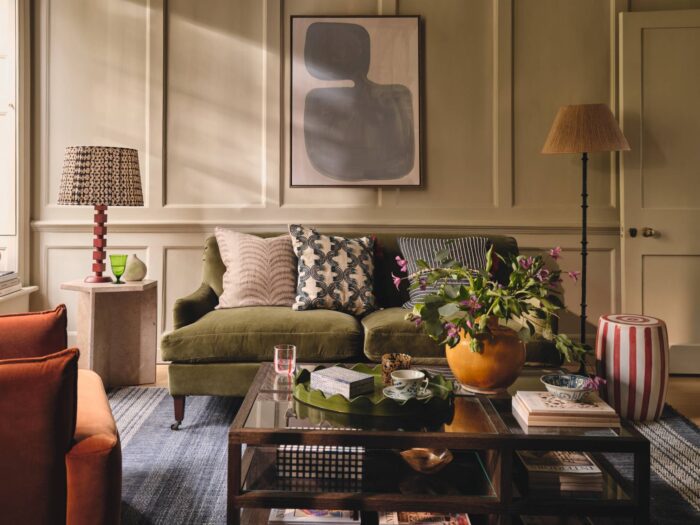 Panelled living room with olive green sofa and large-scale rug