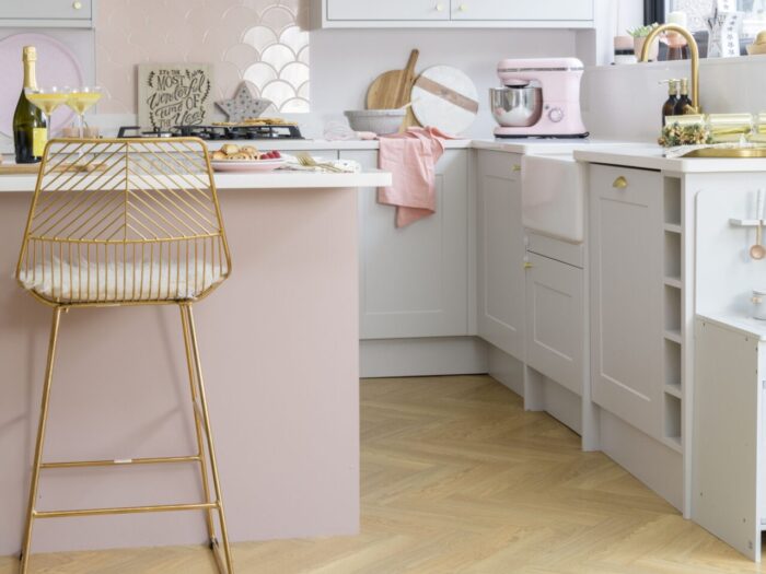 Modern pale pink and white kitchen with island and breakfast bar