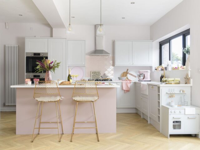 Modern pink and white kitchen with island and breakfast bar