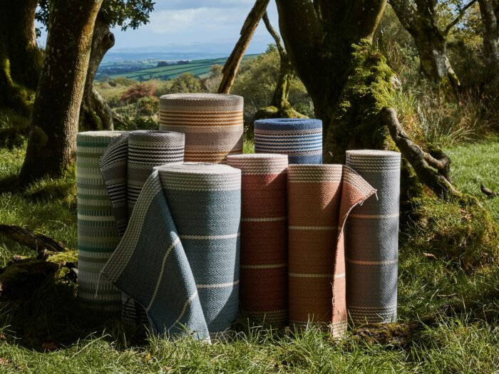 Rolls of carpet under trees in field