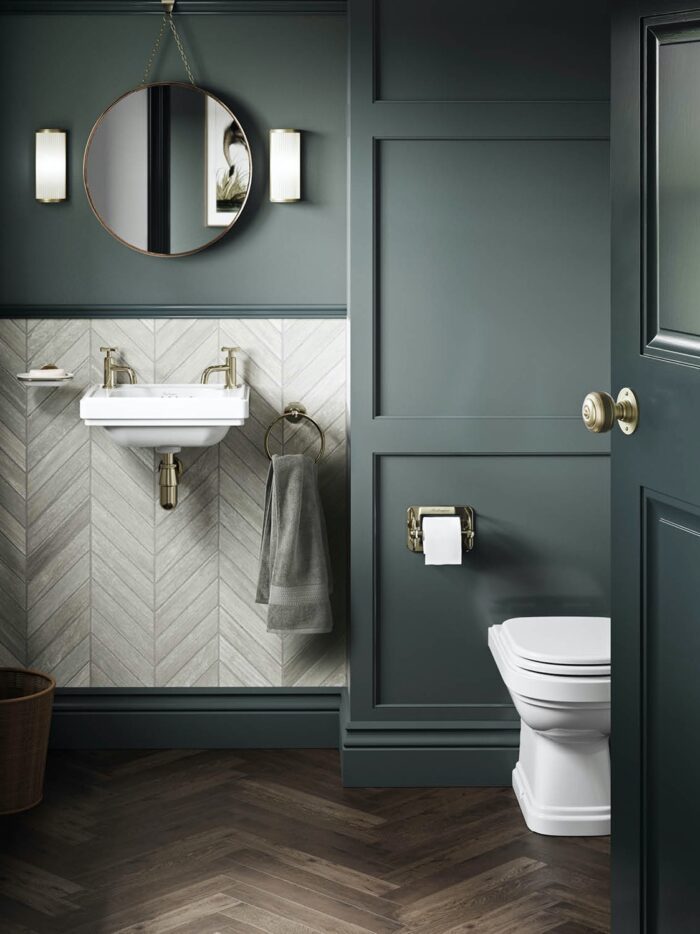 Blue-grey cloakroom with grey marble-look herringbone tiles