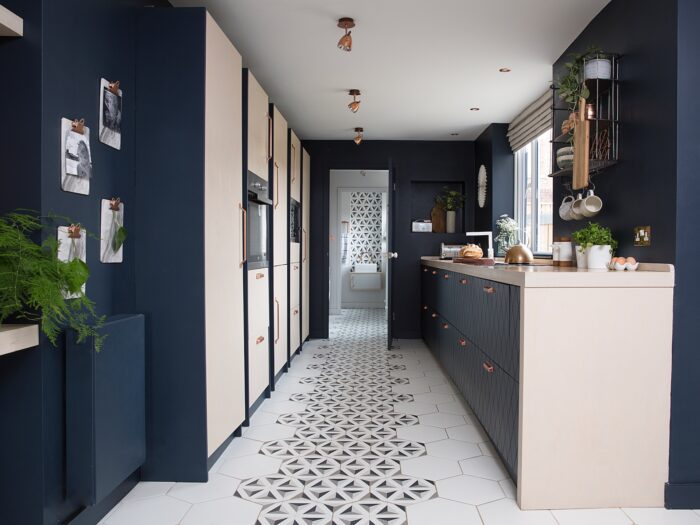 Navy and pale wood kitchen with tiled floor