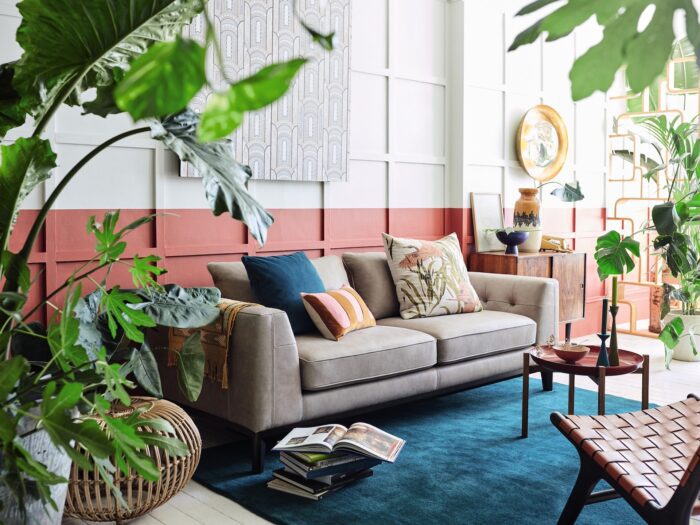 Living rom with pink panelling, grey sofa and houseplants