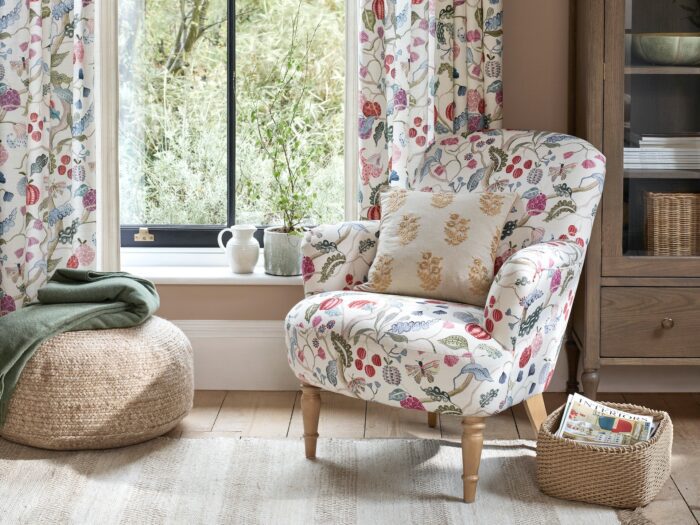 Chair upholstered in floral fabric with matching curtains