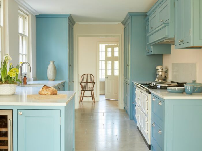 Aqua blue galley kitchen with white Aga