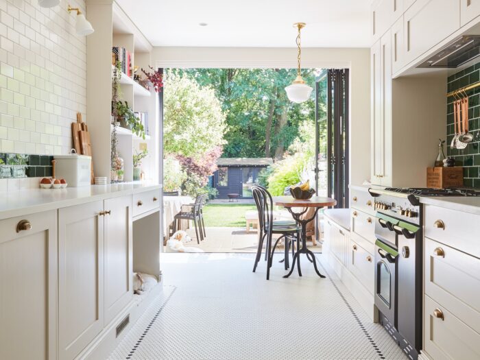 Long galley kitchen opening up to garden with bifold doors