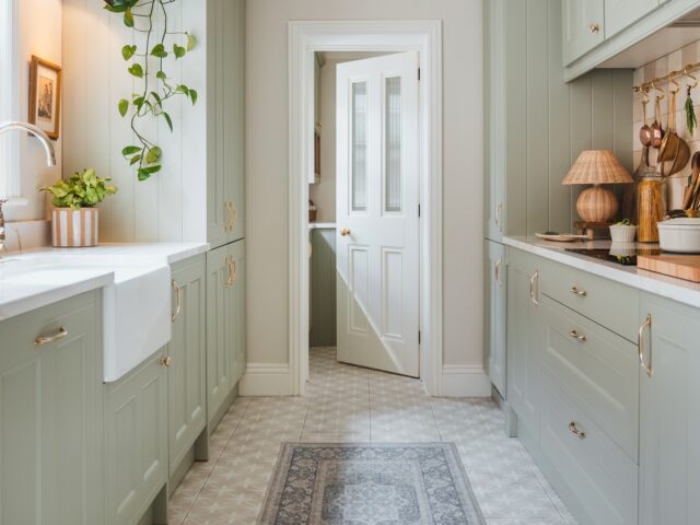 Pale green kitchen with open white door