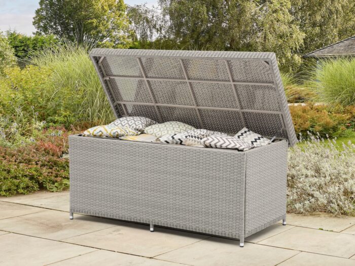 Large rattan garden storage box full of cushions with lid open