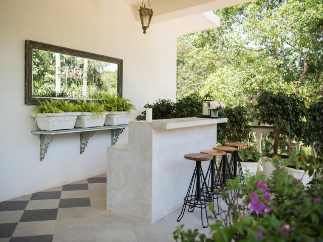 Image of an outdoor mirror in a small garden space