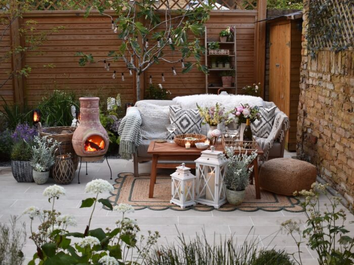Garden at dusk with outdoor sofa and chiminea