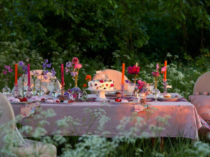 Using brightly coloured candles makes the perfect summer tablescape for an alfresco dinner party