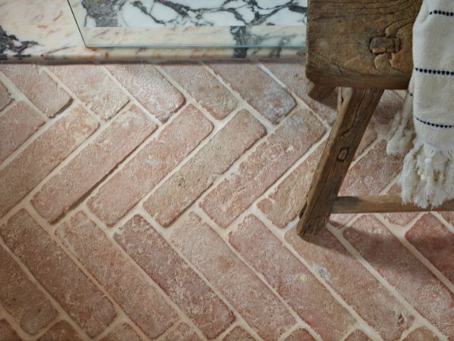 Terracotta herringbone tiles in a bathroom