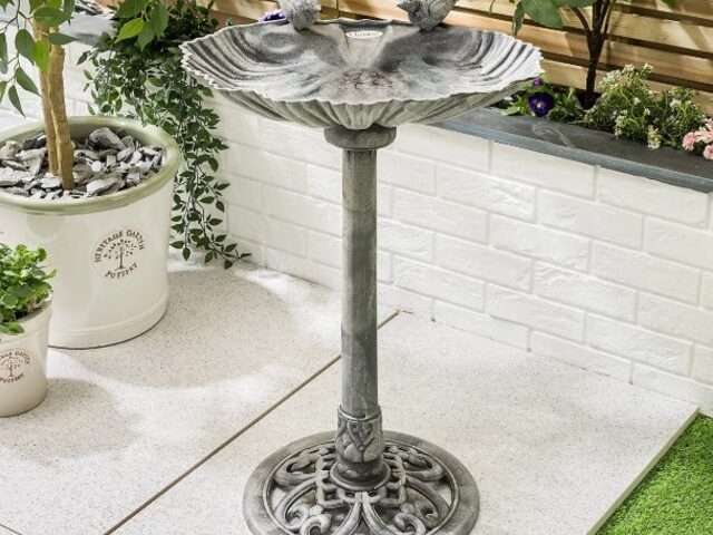 bird baths on stand in metal in courtyard garden