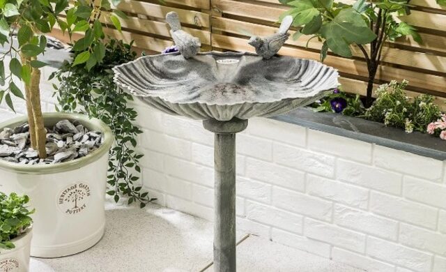 bird baths on stand in metal in courtyard garden