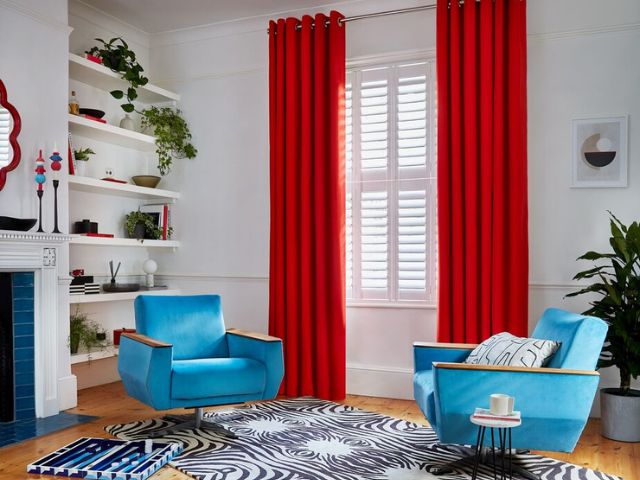 Red curtains in a living room from Hillarys