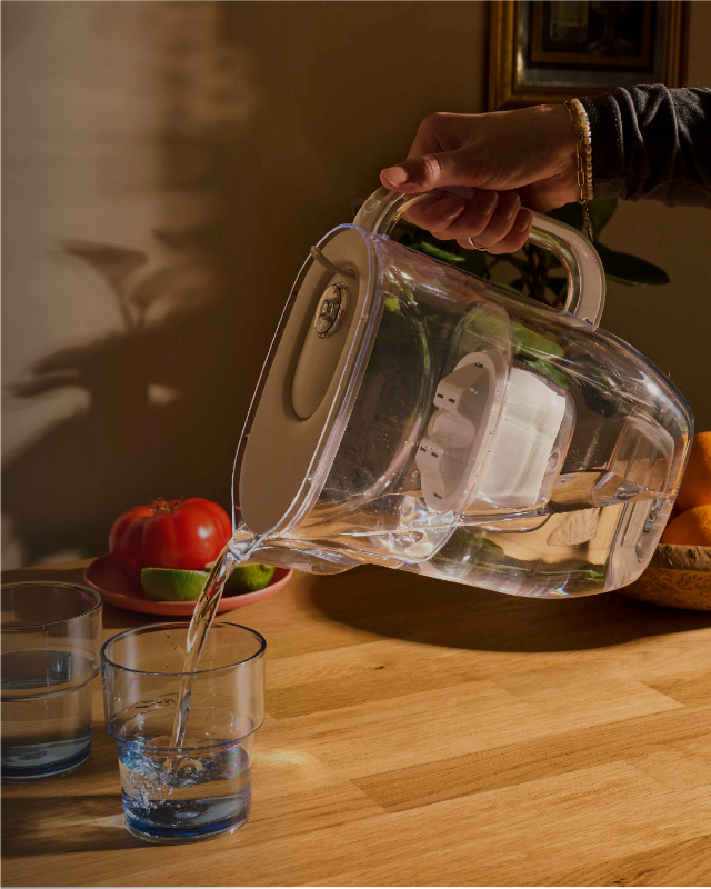 Water jug aquaphor pouring into glass