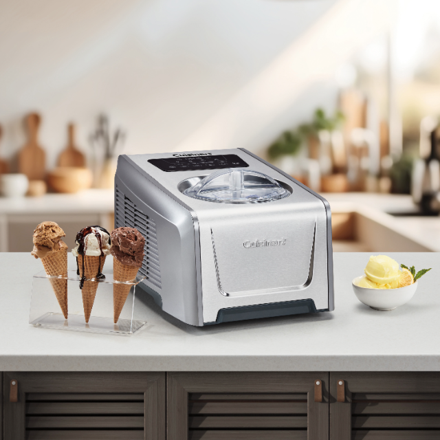 Ice cream maker with ice cream cones beside on kitchen worktop