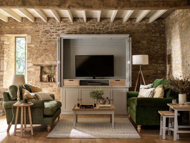 Living room with a hideaway TV unit by Cotswolds Company