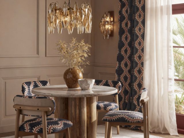 Dining space with chandelier and wall lights