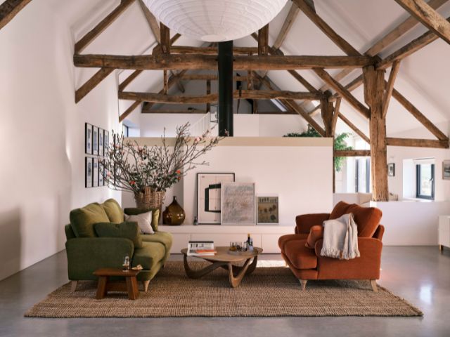 Sociable layout in a living room with orange and green sofas by Loaf