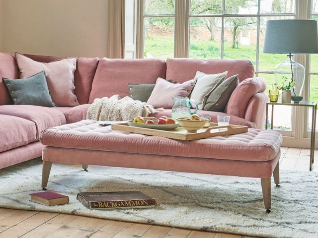 Pastel cushions on a pink sofa by Loaf
